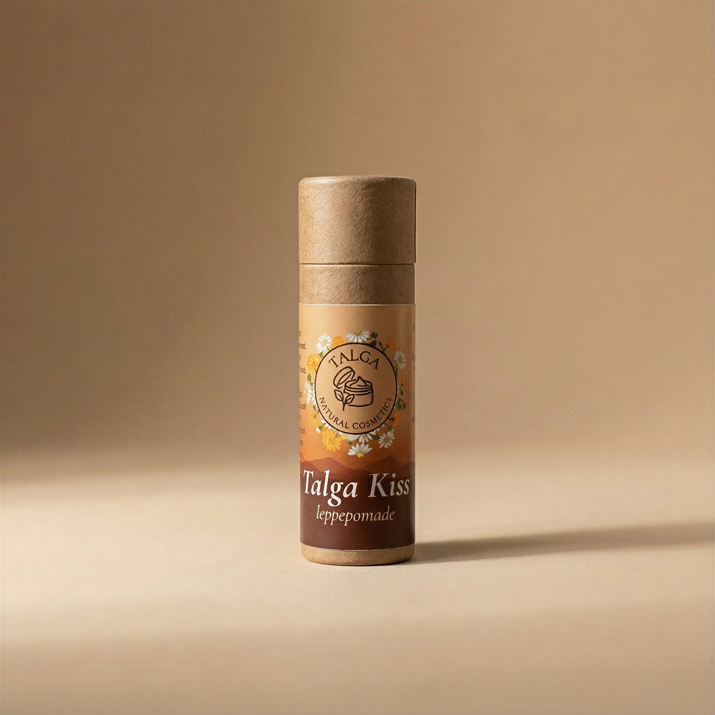 Front view of Talga Kiss leppepomade tallow lip balm in a paper tube on a beige background.