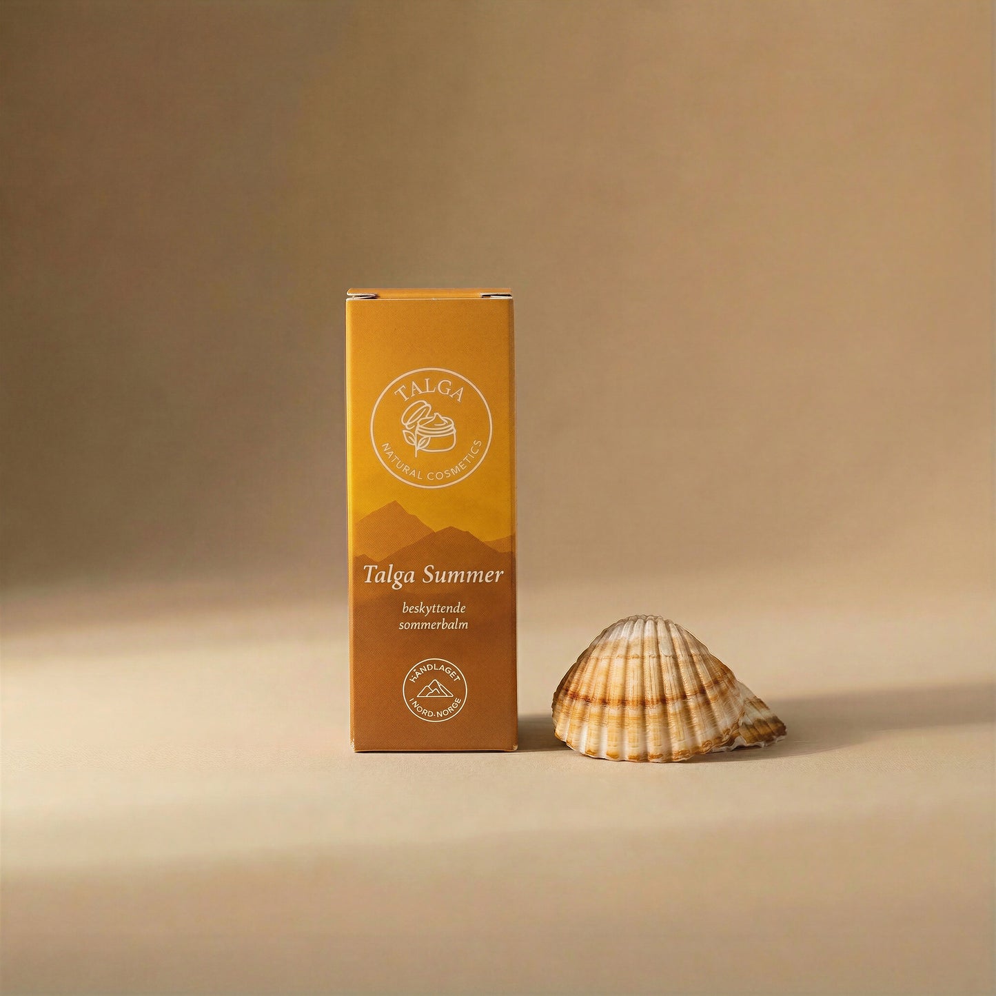 Talga Summer protective balm box on a beige background next to a seashell.